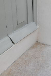 Kaboompics - Pale Blue Paneled Door with Stone Threshold and White Stucco