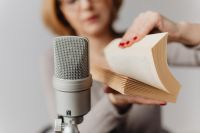 Kaboompics - Woman Flipping through a Book beside Microphone for ASMR Page Sounds