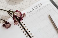 Kaboompics - April 2020 Calendar Planner with Astrantia Flowers and Pen on Checkered Linen