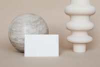 Kaboompics - Vertical Blank Business Card Between Stone Sphere and White Ceramic Vase, Neutral Brand Identity Mockup