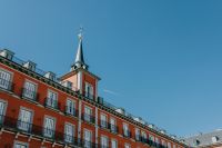 Kaboompics - Red Plaza Mayor Facade and Spire Against Blue Sky
