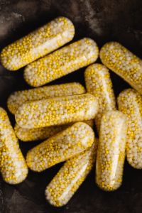 Kaboompics - Close-Up of Bead-Filled Capsules on a Dark Background
