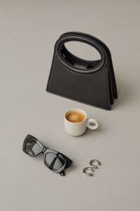 Kaboompics - Black Handbag, Sunglasses, Silver Hoops and Espresso Flat Lay