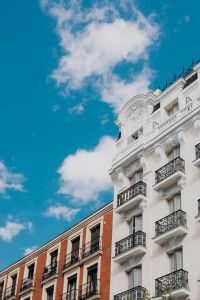 Kaboompics - Vertical Madrid Facade with White Balconies, Brick Details and Blue Sky