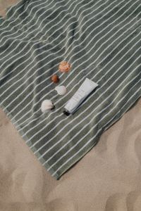 Kaboompics - Striped Beach Towel with Peaches, Seashells and Sunscreen