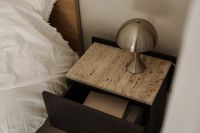 Kaboompics - Open Black Nightstand Drawer with Metallic Lamp beside White Bedding