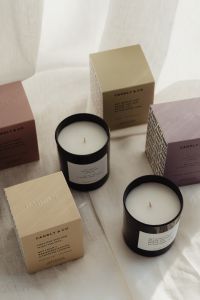 Kaboompics - Black Candles and Fragrance Boxes on White Fabric