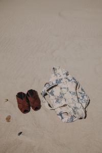 Kaboompics - Brown Sandals and Floral Beach Shirt on the Sand