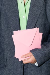 Kaboompics - Person in Gray Blazer Holding Pink Envelopes