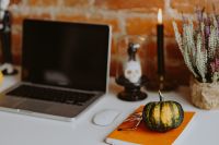 Kaboompics - Laptop and Small Pumpkin Halloween Workspace