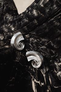 Kaboompics - Close-Up Silver Spiral Earrings on Black Driftwood