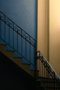 Kaboompics - Indoor Staircase with Ornate Iron Railing on Blue and Beige Wall