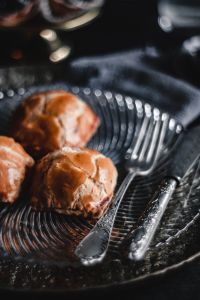 Kaboompics - Two Golden Sweet Buns with Silver Cutlery