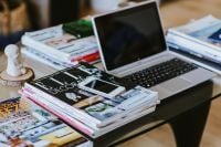 Kaboompics - Silver laptop with magazines and a white smartphone