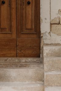 Kaboompics - Double Wooden Door with Paneled Facade and Limestone Steps