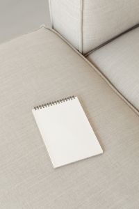 Kaboompics - Diagonal Blank Notebook Mockup on Beige Sofa Cushions