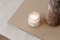 Kaboompics - Candle on Art Book Beside Textured Vase