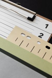 Kaboompics - Close Up of Clipboard and Layered Graphic Design Papers
