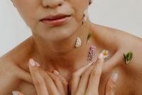 Kaboompics - Lower Face and Shoulder Beauty Portrait with Hand Touching Daisy and Wildflower Accents