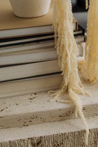 Kaboompics - Close-Up of Travertine Table with Books and Fringed Textile