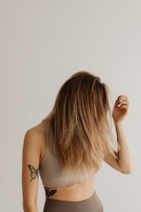 Kaboompics - Back View of Woman With Long Hair Against a Neutral Wall