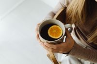 Kaboompics - Woman Holding a Cup of Tea While Sitting
