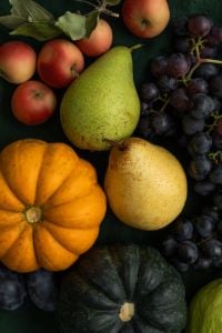 Kaboompics - Moody Autumn Produce Flat Lay With Pumpkin Pear Grapes and Apples