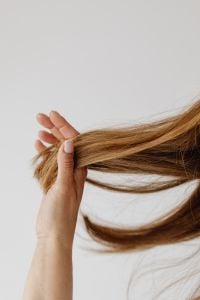 Kaboompics - Fingers Holding the Ends of Long Blonde Hair