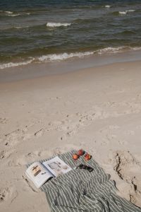 Kaboompics - Open VOGUE Magazine on a Beach Towel by the Sea
