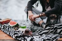 Kaboompics - Blonde woman having a healthy snack at the wooden pier