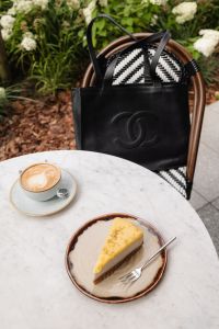 Kaboompics - Coffee and Cake Beside a Black Leather Handbag
