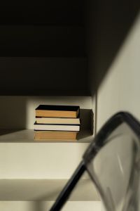 Kaboompics - Reading Aesthetic with Books and Eyeglasses on Sunlit Shelf