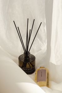 Kaboompics - Reed Diffuser with Fragrance Bottle on White Linen
