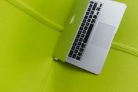 Kaboompics - Laptop Keyboard Seen From Above on a Green Lounge Chair