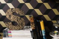 Kaboompics - Decorative Letter "S" on a stack of magazines