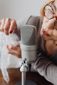 Kaboompics - Close-Up Hand Pressing Bubble Wrap beside Microphone for ASMR Triggers