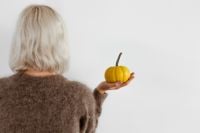 Kaboompics - Woman Holding Yellow Pumpkin From Behind