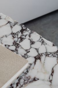 Kaboompics - Close-Up of Irregular Marble Table Edge and Beige Linen Book