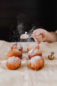 Kaboompics - Powdered Sugar Falling onto Fresh Polish Paczki on Cream Linen, Dark Studio Background