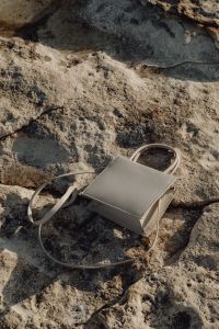 Kaboompics - White Mini Crossbody Bag on Sunlit Limestone