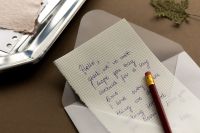 Kaboompics - Handwritten Letter in Open Envelope with Pencil and Dried Leaf