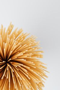 Kaboompics - Uncooked Spaghetti Bursting into White Copy Space for Italian Recipe Layouts