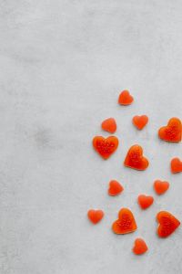 Kaboompics - Orange Heart Candies Clustered With Copy Space