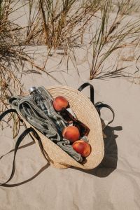 Kaboompics - Straw Beach Bag Filled with a Towel and Peaches