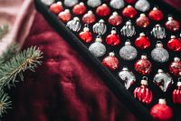 Kaboompics - Christmas Ornament Arrangement with Evergreen Branch and Red Baubles