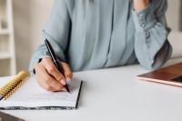Kaboompics - Close-Up of Hand Writing in a Notebook at a Desk