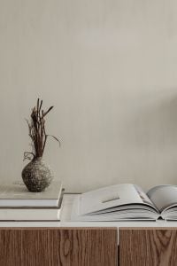 Kaboompics - Textured Ceramic Vase with Dried Branches and Open Design Book, Neutral Interior