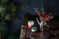 Kaboompics - Christmas Table Decor with Holly Berries and Red Candles on Dark Wood