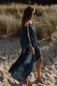 Kaboompics - Barefoot Woman Walking in Blue Kaftan Through Dunes