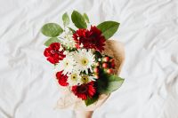 Kaboompics - Wrapped Red Bouquet on White Linen With Copy Space